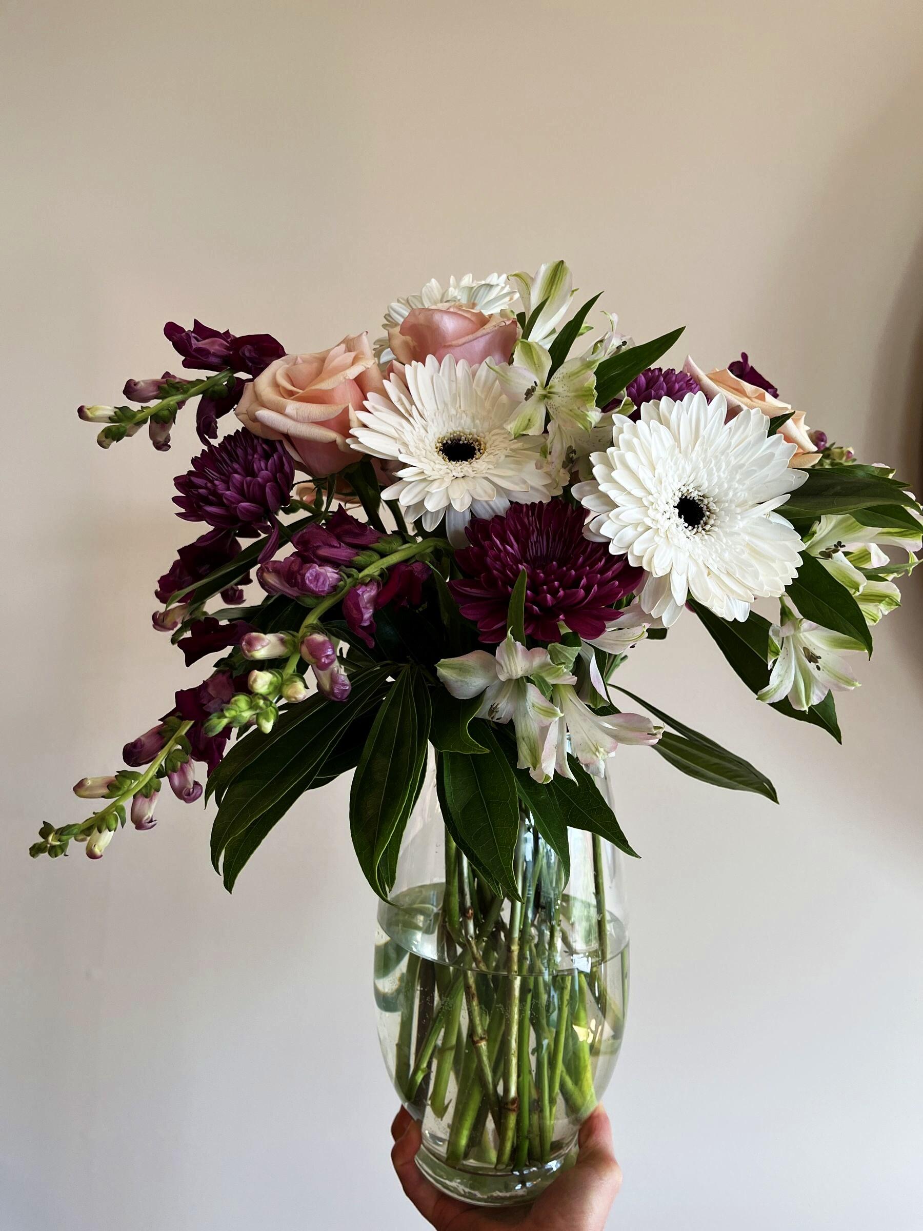 Hand-tied seasonal bouquet held up